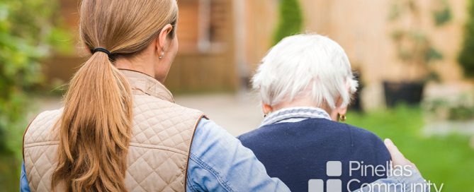Caregiver walking with dementia patient.