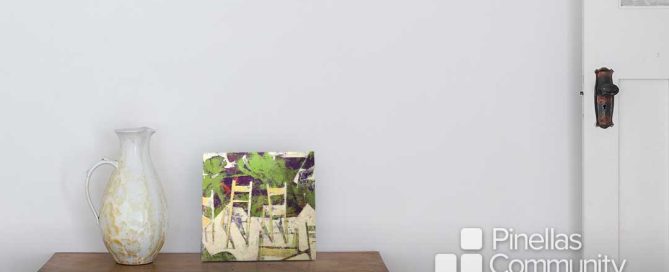 Abstract artwork of chairs on entryway table.