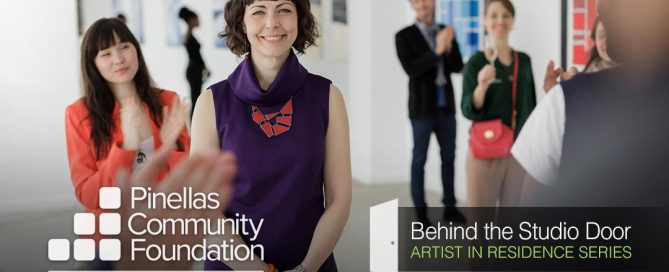 Artist finding support from colleagues at exhibit.