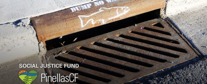 Storm drain on roadside with painting on it to prevent littering and dumping.