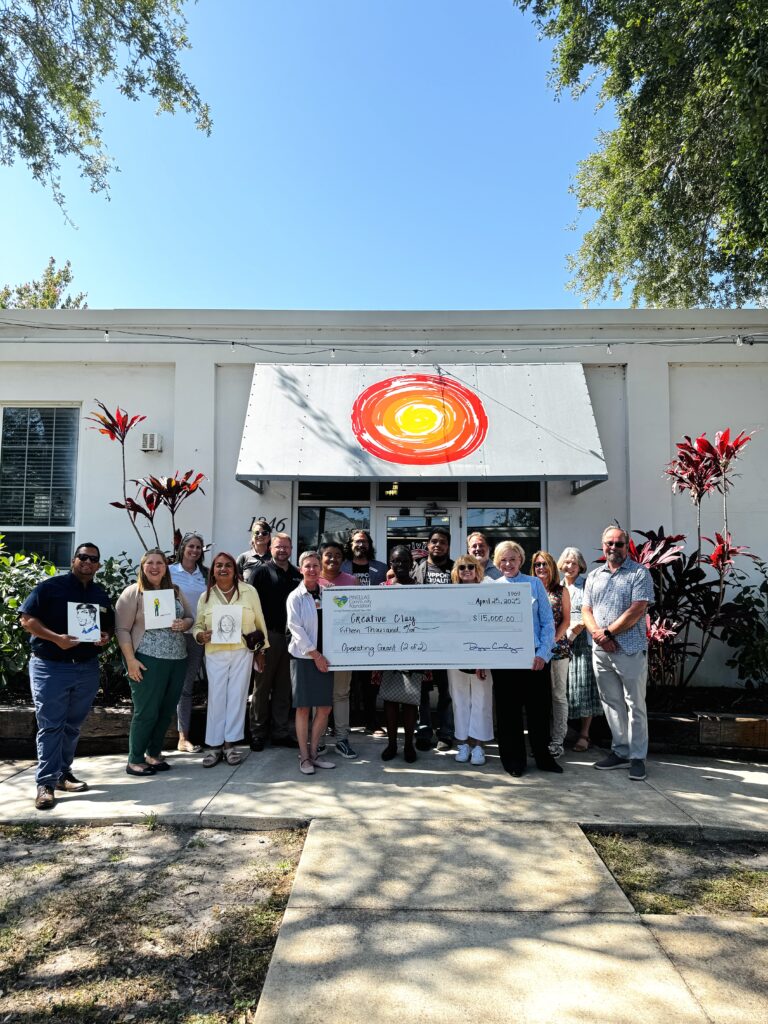 Creative Clay artists and staff posing with Pinellas Community Foundation and a check presentation for an operating grant