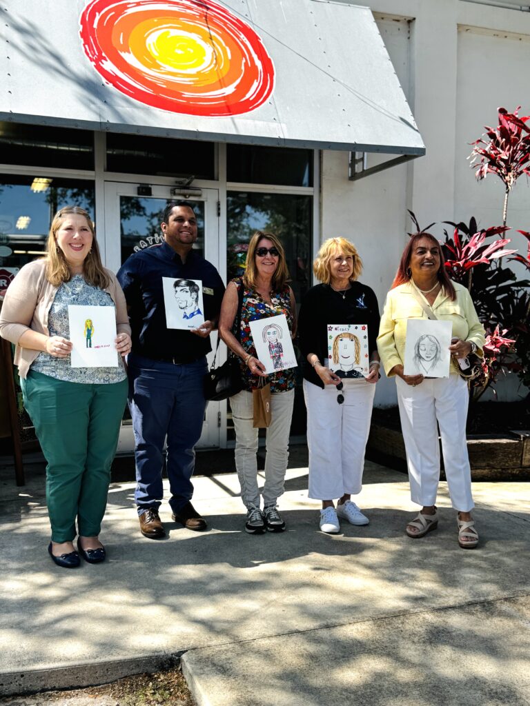 Creative Clay Center, Pinellas Community Foundation donors and board members posing with their artists' portraits