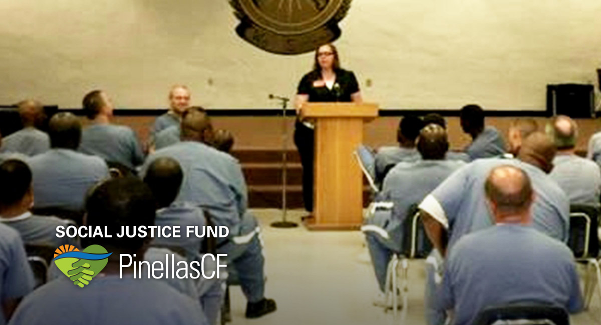 Bethany McNeil of XO Factor speaks to a room full of prisoners awaiting release.