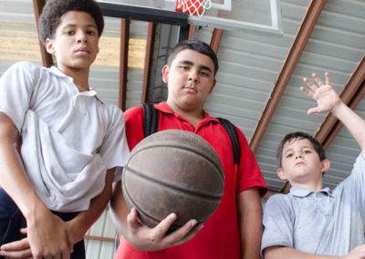 Three boys ready to play basketball.